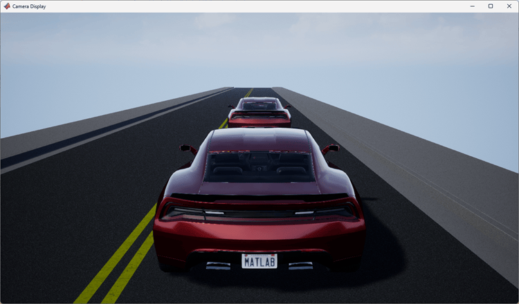 Camera display window showing rear view of a red vehicle following another car on a two-lane road